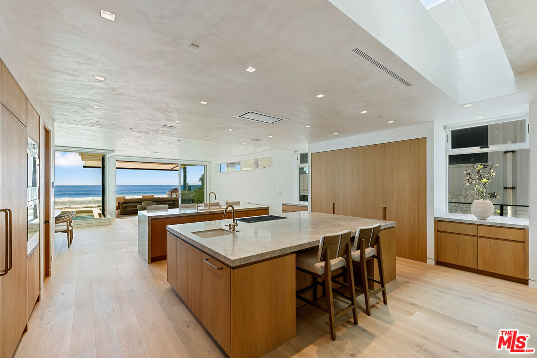 31224 Broad Beach Road Malibu, CA 90265 - Photo 13 of 54 a kitchen with a table chairs and wooden floor