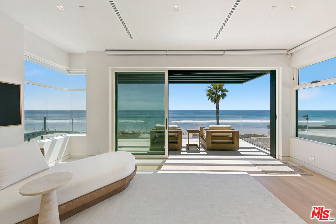 31224 Broad Beach Road Malibu, CA 90265 - Photo 24 of 54 a living room with a balcony a large window and couch