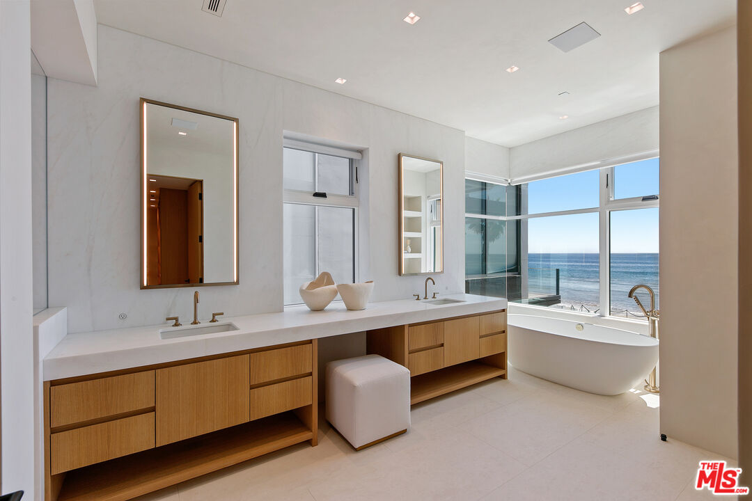 31224 Broad Beach Road Malibu, CA 90265 - Photo 28 of 54 a bathroom with a double vanity sink tub double and mirror