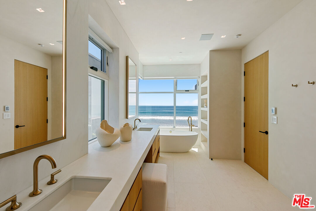 31224 Broad Beach Road Malibu, CA 90265 - Photo 29 of 54 a dining room with stainless steel appliances furniture a window and a kitchen view