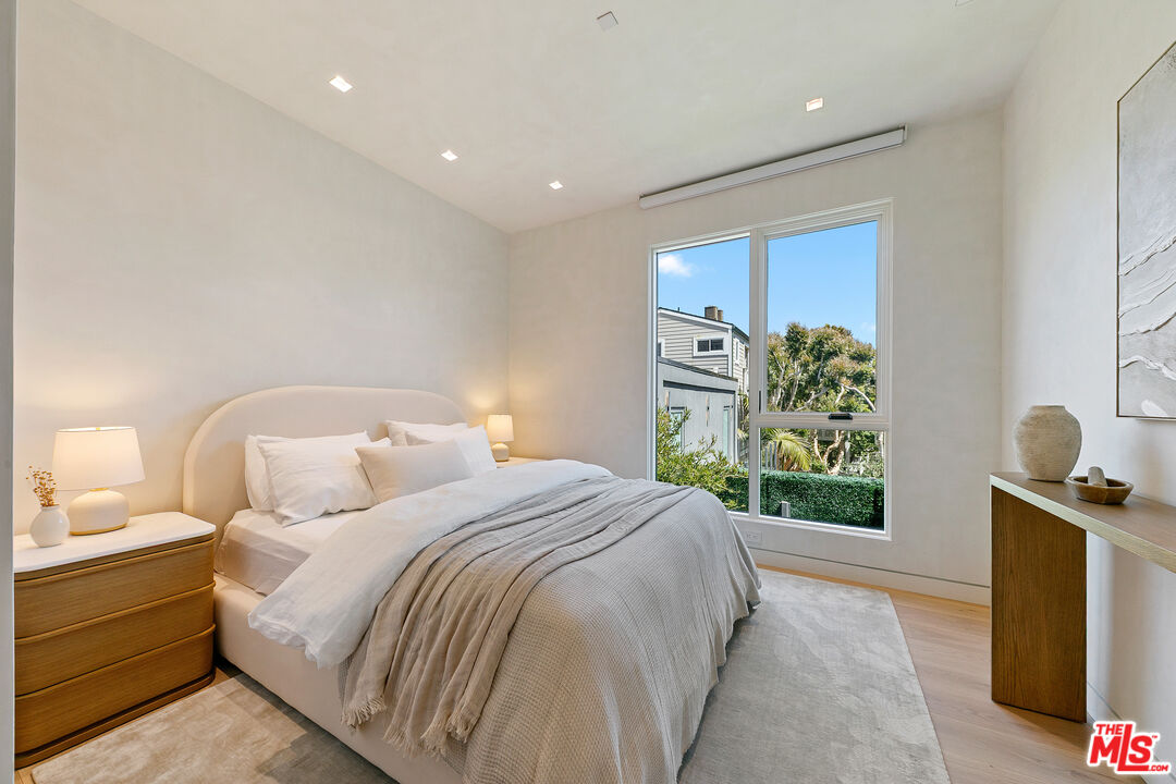 31224 Broad Beach Road Malibu, CA 90265 - Photo 35 of 54 a spacious bedroom with a bed and a window