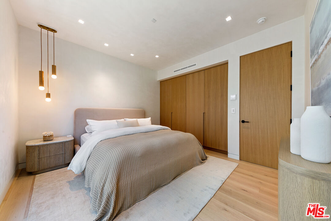 31224 Broad Beach Road Malibu, CA 90265 - Photo 37 of 54 a bedroom with a large bed and wooden floor