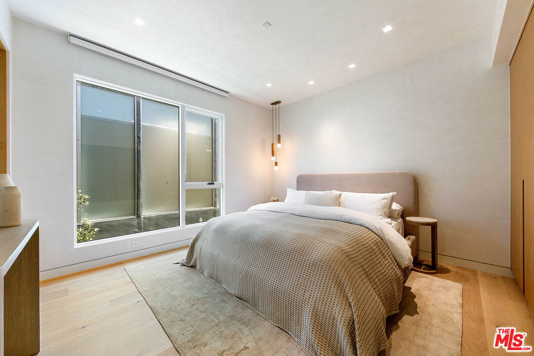 31224 Broad Beach Road Malibu, CA 90265 - Photo 38 of 54 a spacious bedroom with a bed and a large window