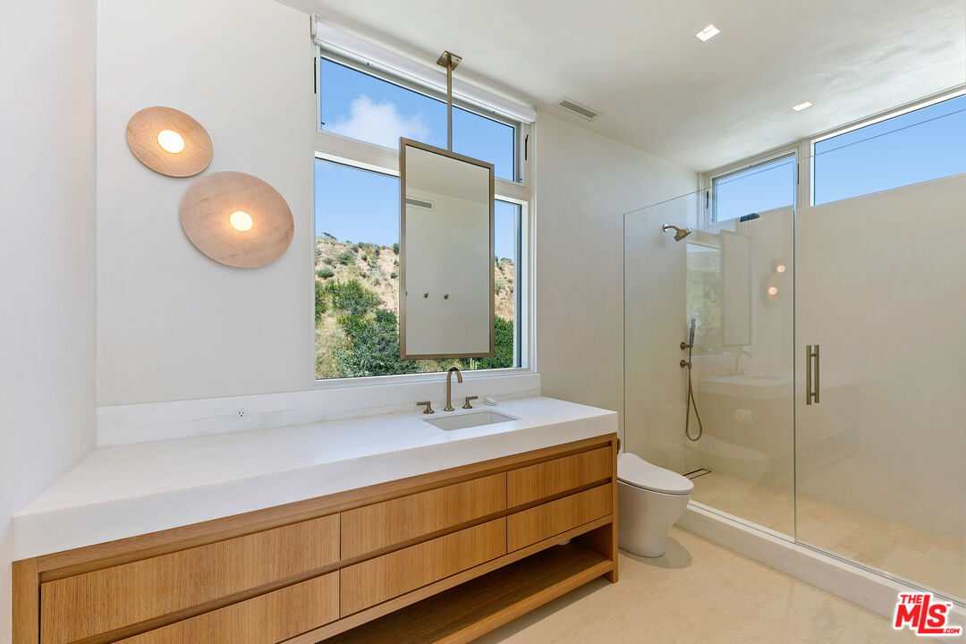 31224 Broad Beach Road Malibu, CA 90265 - Photo 45 of 54 a bathroom with a double vanity sink toilet mirror and shower