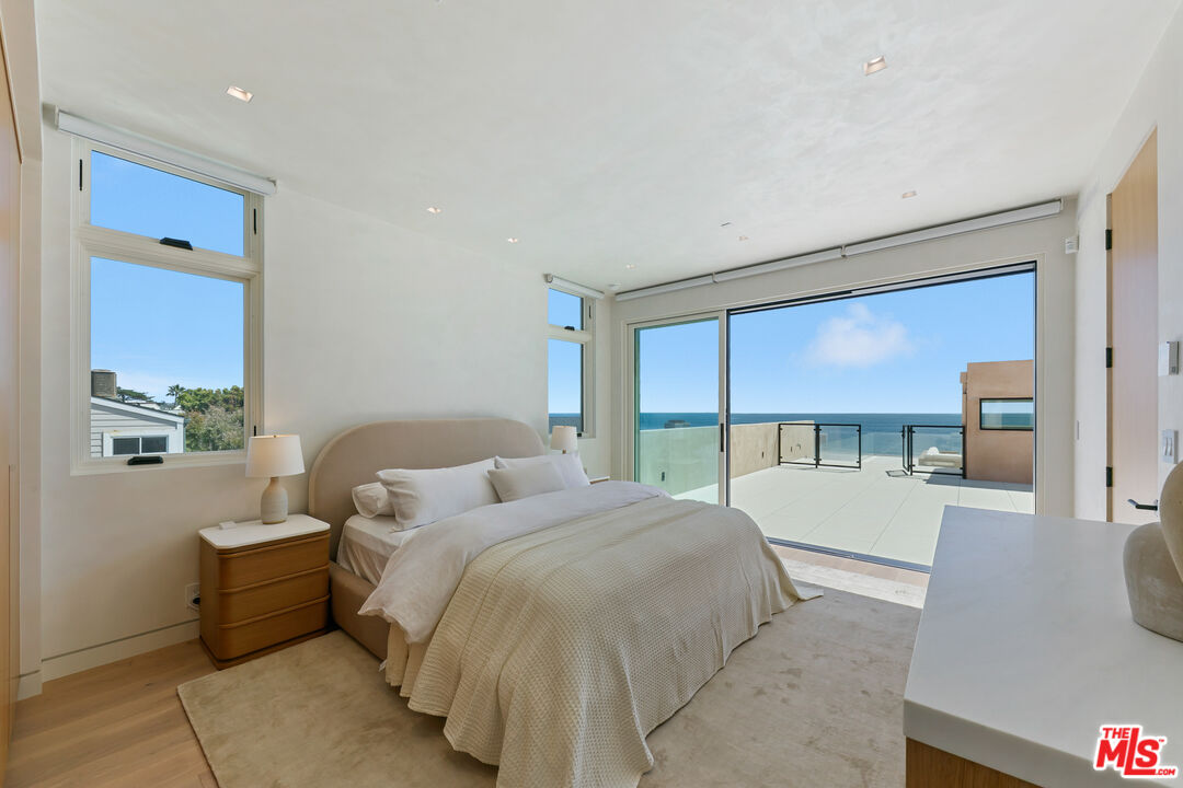 31224 Broad Beach Road Malibu, CA 90265 - Photo 47 of 54 a spacious bedroom with a bed and large windows