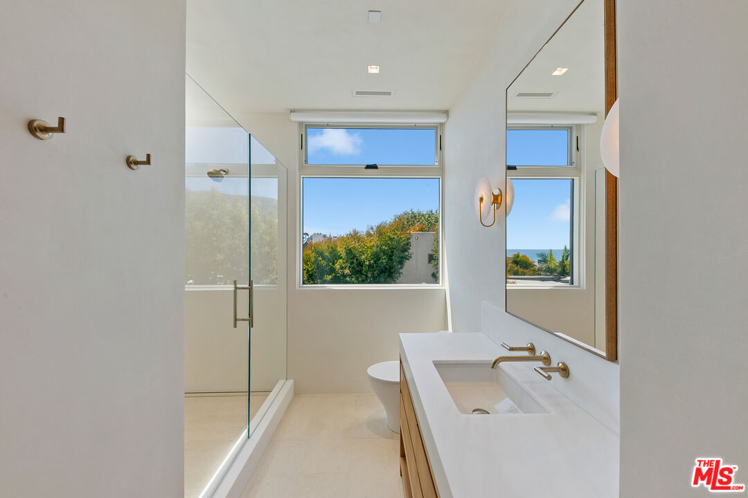 31224 Broad Beach Road Malibu, CA 90265 - Photo 48 of 54 a bathroom with a tub sink and mirror