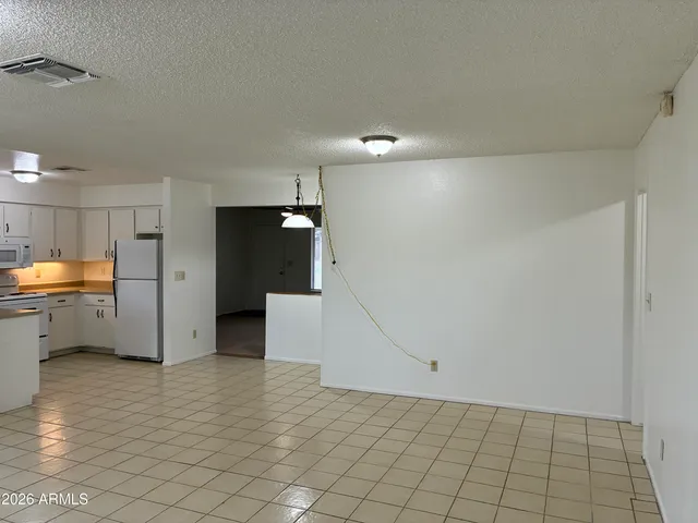 a view of a refrigerator in kitchen and utility room