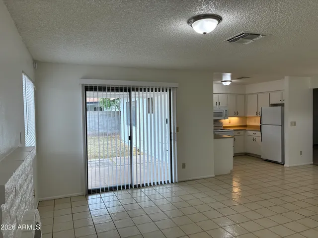 a view of a room with a kitchen