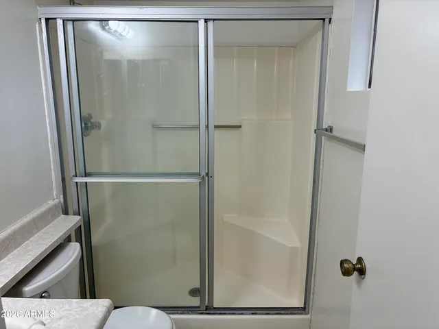 a bathroom with a glass door shower