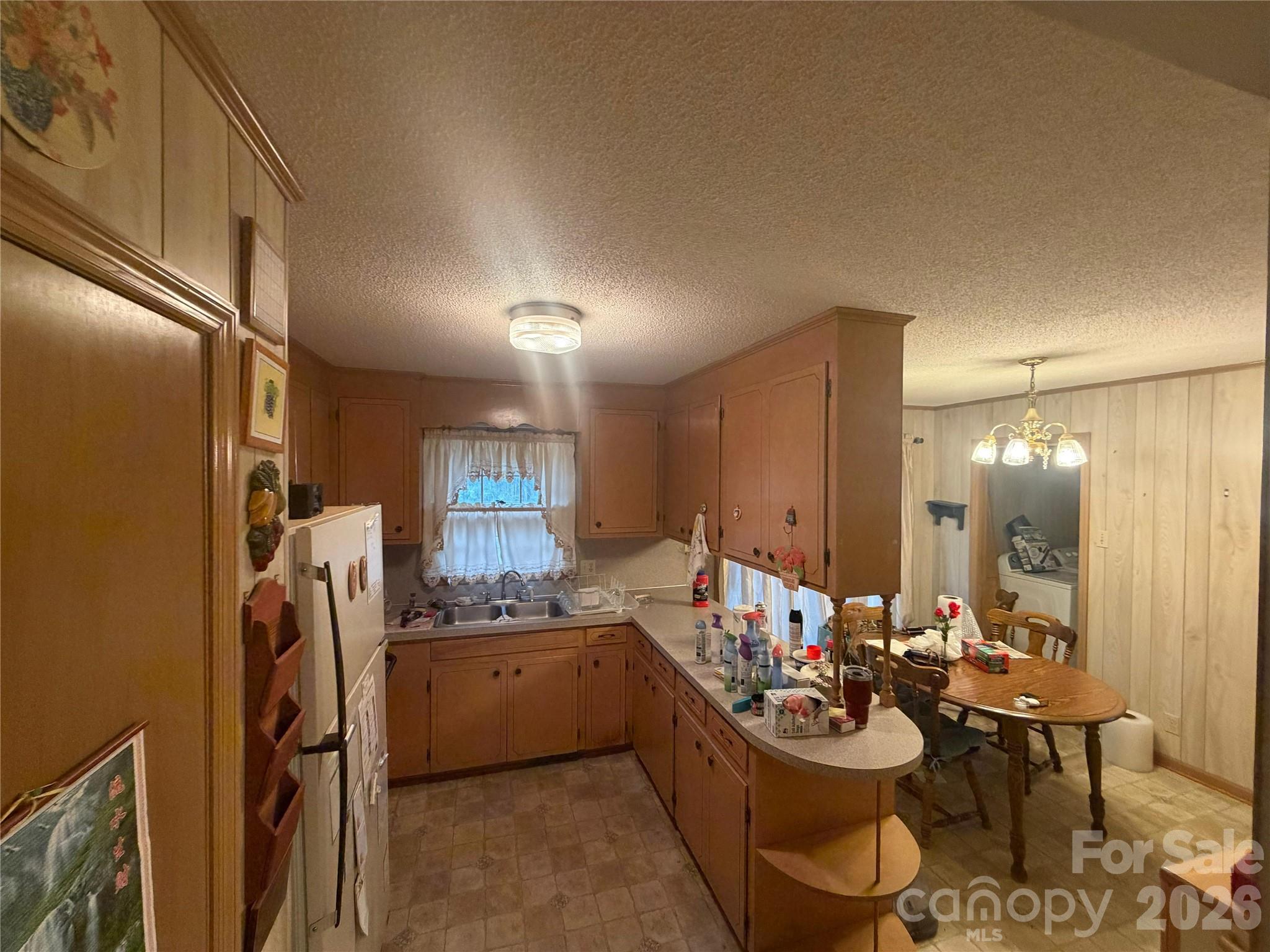 2990 Flat Creek Road Lancaster, SC 29720 - Photo 4 of 13 a room with stainless steel appliances kitchen island granite countertop furniture and a refrigerator