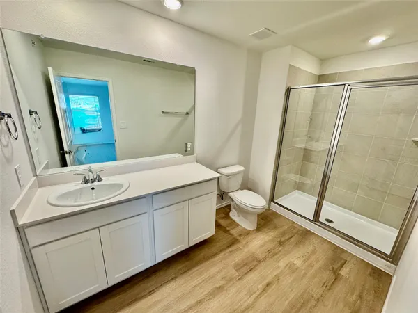 a bathroom with a double vanity sink toilet and shower