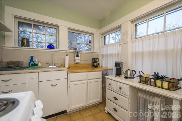 a kitchen with sink cabinets and window