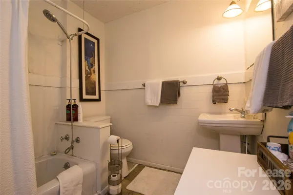 a bathroom with a sink toilet and mirror