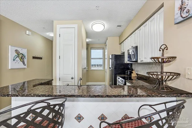a kitchen with a sink a stove and cabinets