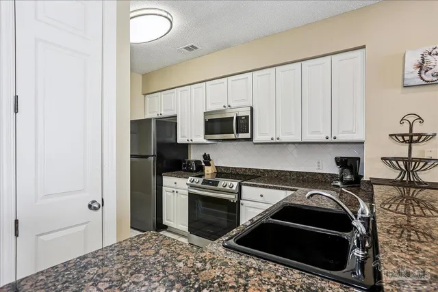 a kitchen with a stove and a microwave