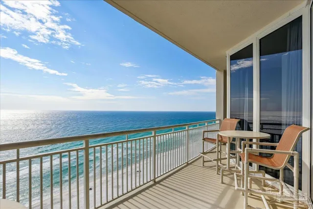 a view of a chairs and table in patio with wooden floor