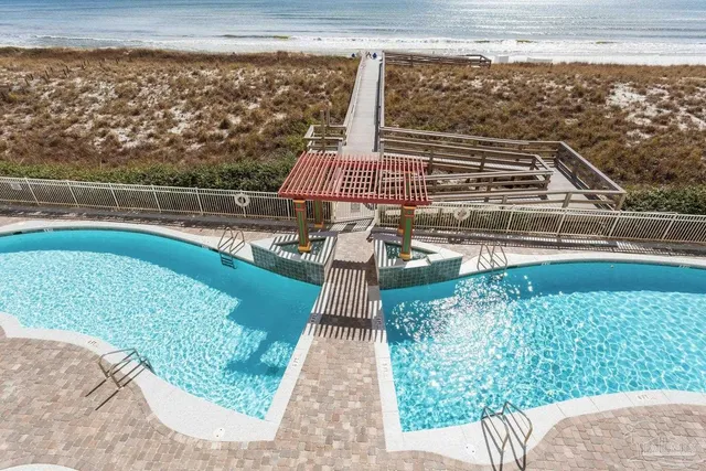 a view of a balcony with floor to ceiling windows with wooden floor