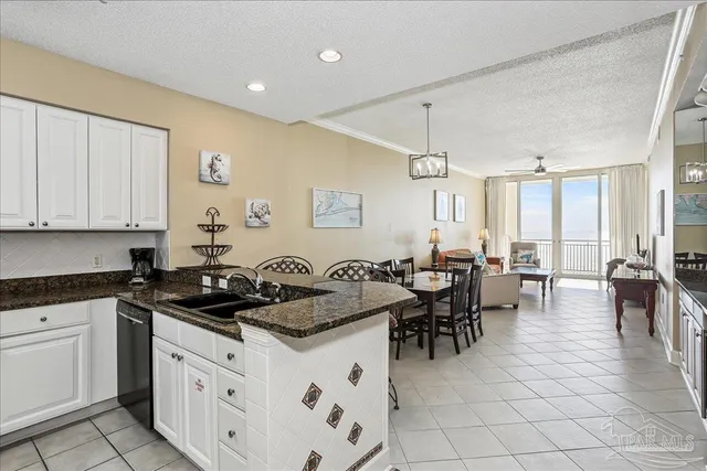 a kitchen with a dining table chairs and white appliances