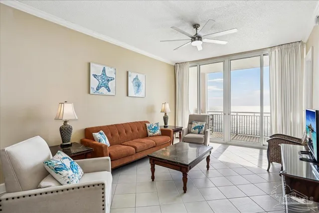 a living room with furniture and a large window with wooden floor