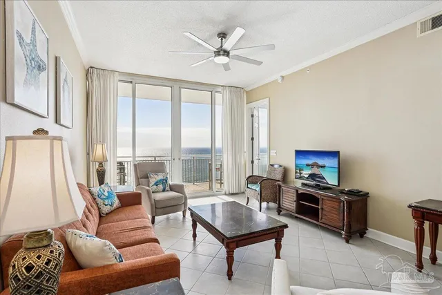 a living room with furniture and a large window with wooden floor