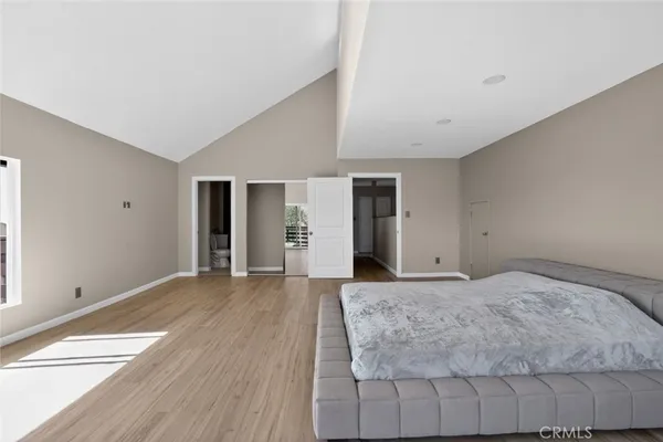 a bedroom with a large bed and window