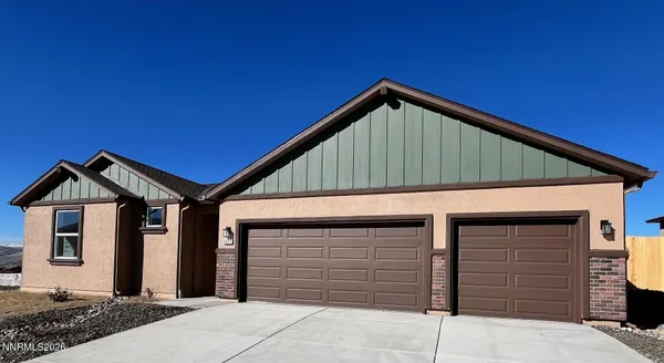 a front view of a house with garage