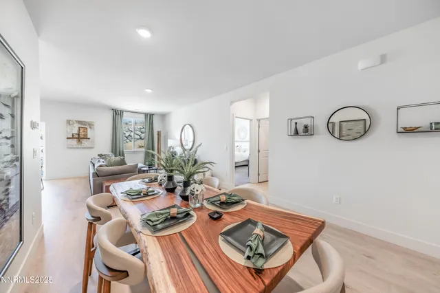 a kitchen with stainless steel appliances granite countertop a stove top oven a refrigerator a sink and dishwasher a oven with wooden floor