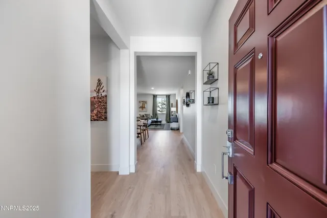 a living room with furniture and view of kitchen
