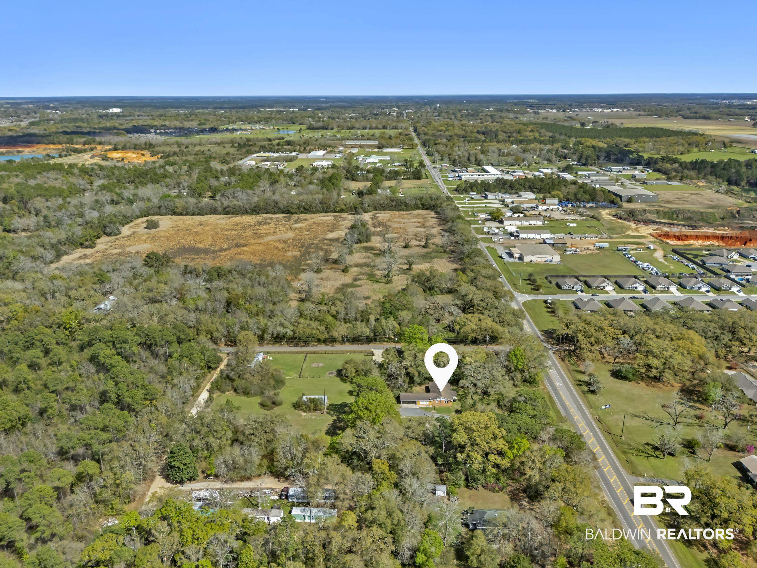 17463 Highway 98 Foley, AL 36535 - Photo 47 of 57 Aerial view of property and surrounding area featuring a forest and nearby suburban area