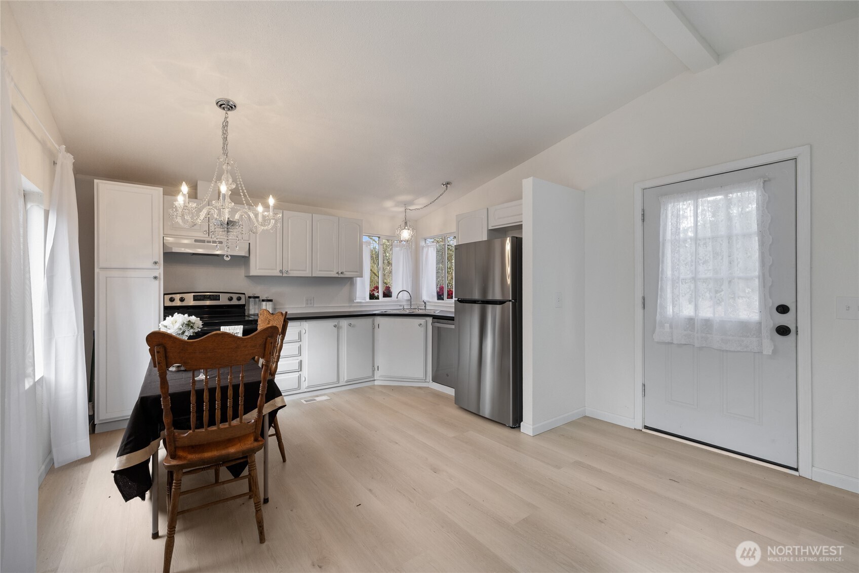14512 246th Street East Graham, WA 98338 - Photo 11 of 39 a kitchen with refrigerator and chairs