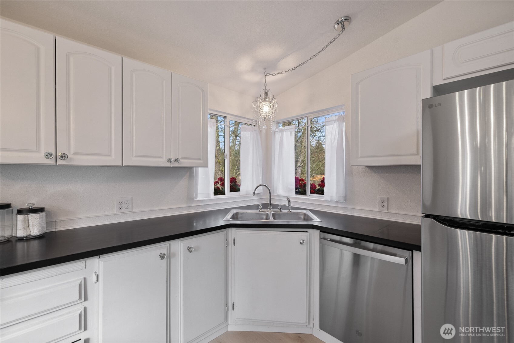 14512 246th Street East Graham, WA 98338 - Photo 12 of 39 a kitchen with stainless steel appliances granite countertop a sink a refrigerator and white cabinets