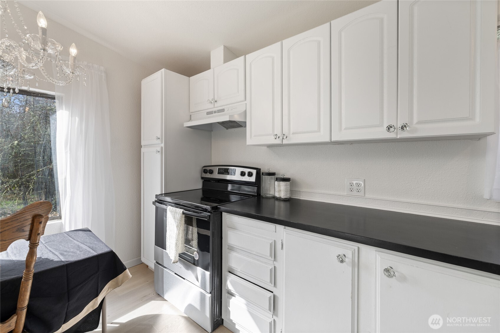 14512 246th Street East Graham, WA 98338 - Photo 14 of 39 a kitchen with stainless steel appliances granite countertop a sink stove and cabinets