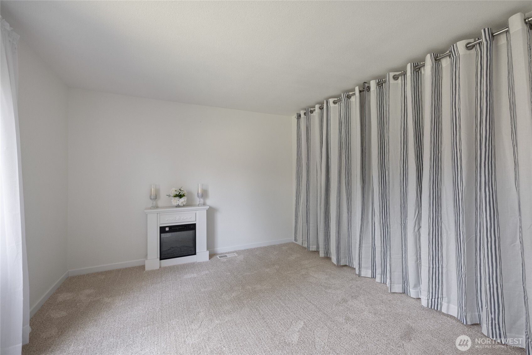 14512 246th Street East Graham, WA 98338 - Photo 18 of 39 a view of an empty room with a fireplace