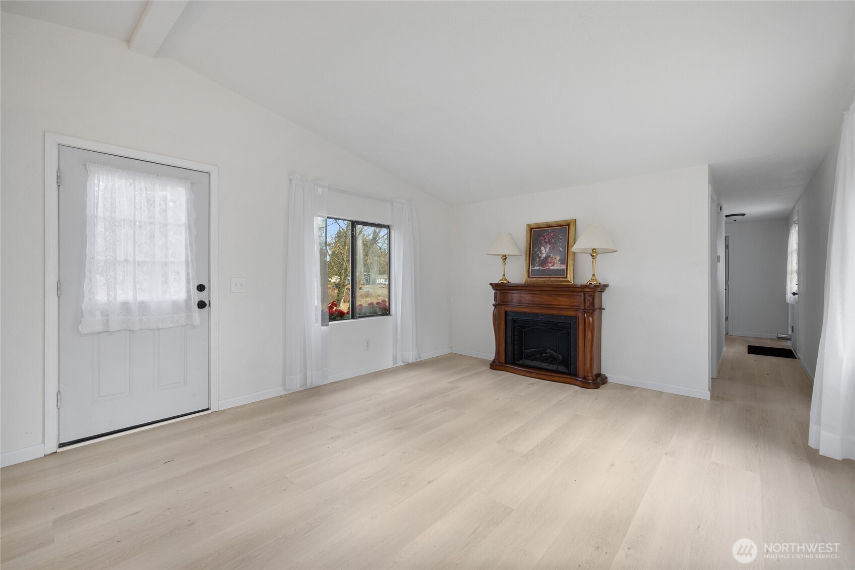 14512 246th Street East Graham, WA 98338 - Photo 8 of 39 a view of an empty room with a fireplace and a window