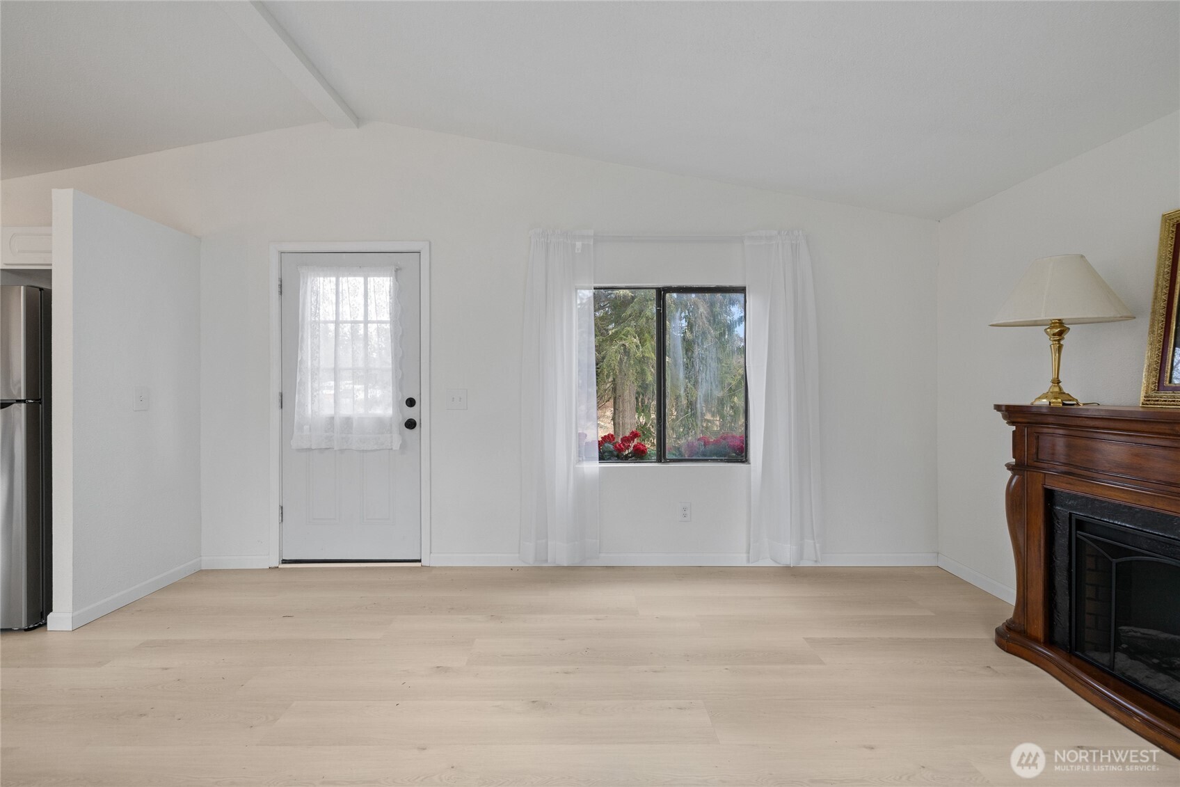 14512 246th Street East Graham, WA 98338 - Photo 9 of 39 a view of empty room with window and fireplace