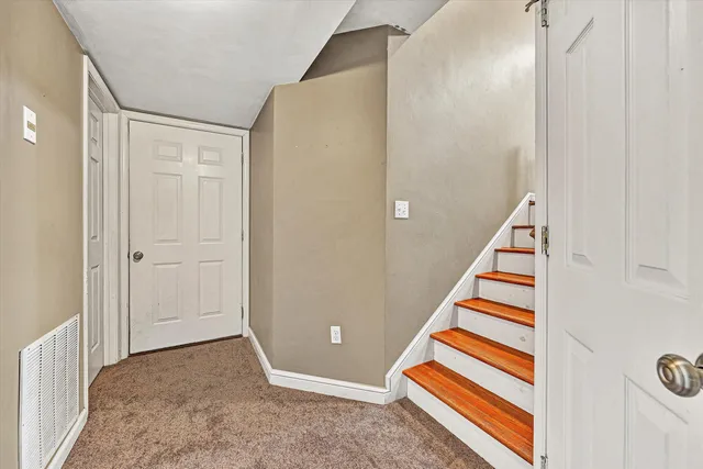 a view of entryway with stairs and white door