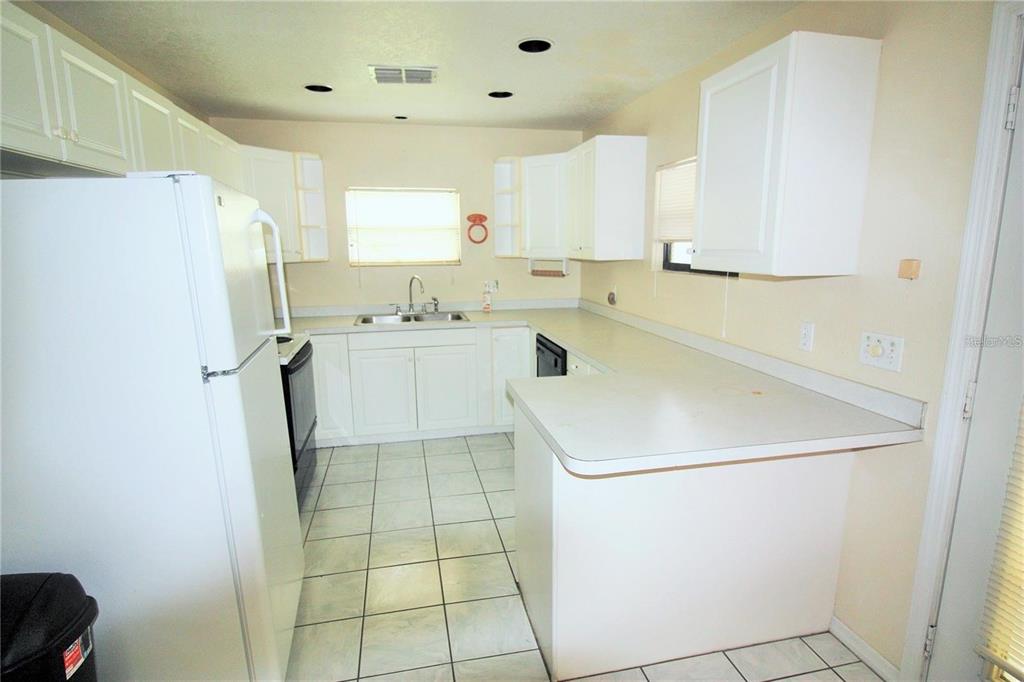 521 20th Street Southwest, Unit C Winter Haven, FL 33880 - Photo 3 of 18 a utility room with cabinets washer and dryer
