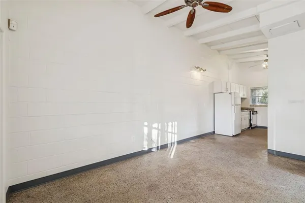 a view of empty room with ceiling fan