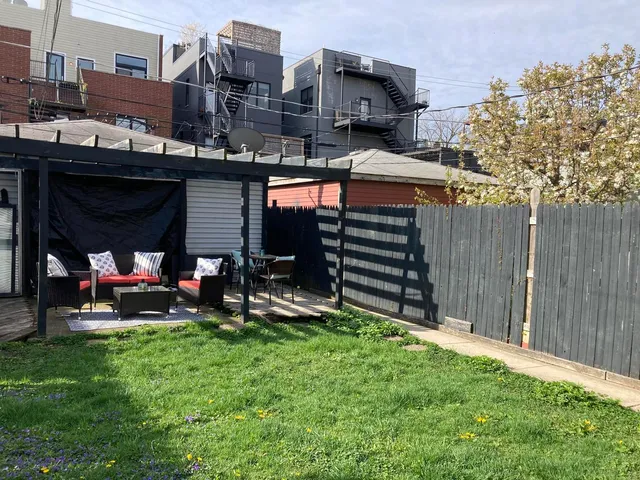 a view of a chairs and table in a backyard