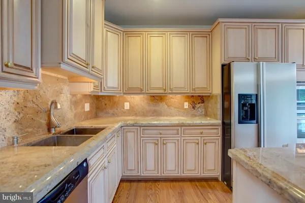 a kitchen with stainless steel appliances granite countertop a stove and a refrigerator