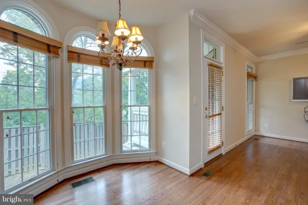 a kitchen with granite countertop a refrigerator stove and cabinets
