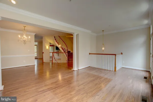 wooden floor fireplace and windows in an empty room