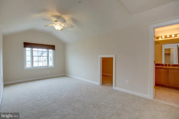 a bathroom with a sink a toilet a mirror and shower