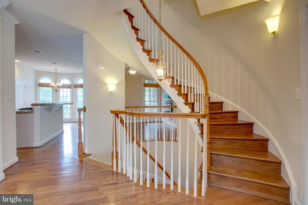 a view of a livingroom with a hardwood floor and a ceiling fan