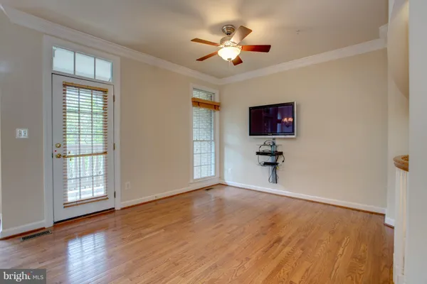 a view of kitchen with microwave and wooden floor