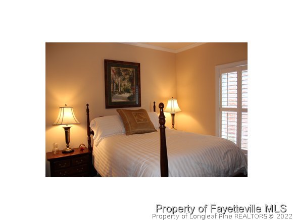 1816 Morganton Road Fayetteville, NC 28305 - Photo 17 of 24 a bedroom with a bed and a lamp