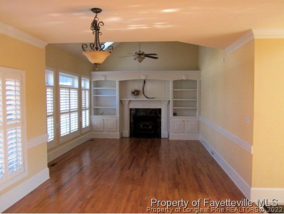 1816 Morganton Road Fayetteville, NC 28305 - Photo 3 of 24 a view of an empty room with a fireplace and a window