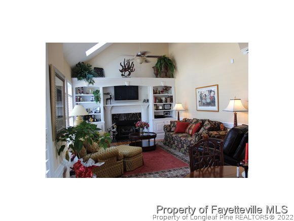 1816 Morganton Road Fayetteville, NC 28305 - Photo 4 of 24 a living room with furniture a fireplace and a potted plant
