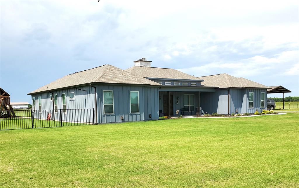 a view of a house with a yard and sitting area