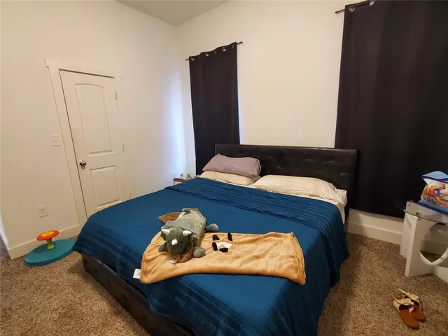 a bedroom with a bed and a painting on the wall